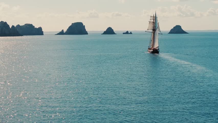 Sailing ship heading toward Tas de Pois rocks near Camaret-sur-Mer, Brittany, France