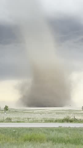 A strong tornado spins beneath a supercell thunderstorm during a severe weather event near Bennett, Colorado. 