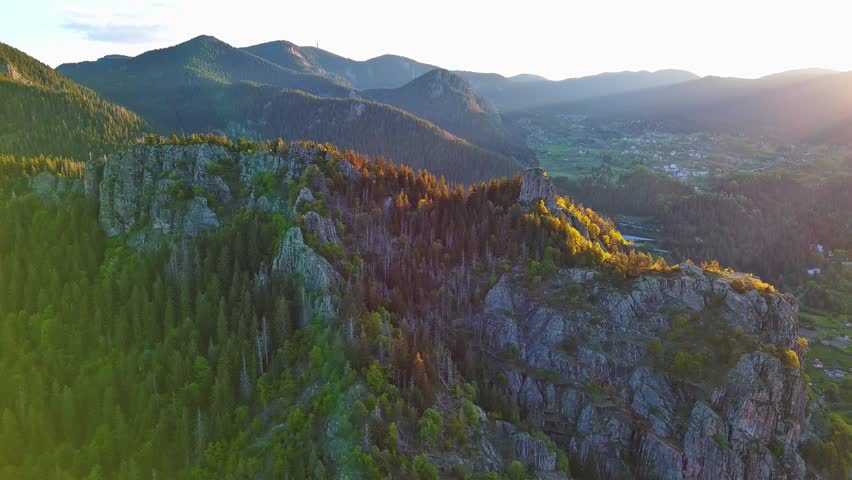 View from rock to town of Smolyan with meadows for cattle walking and houses between mountain range of Rhodope Mountains