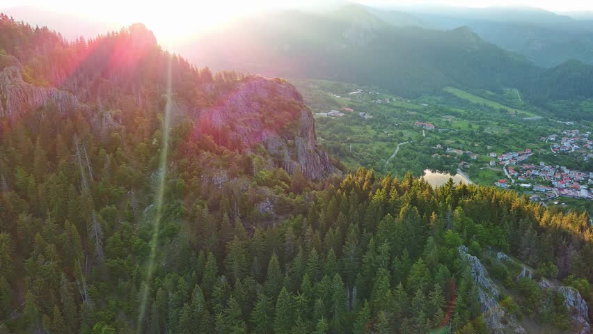 View from rock to town of Smolyan with meadows for cattle walking and houses between mountain range of Rhodope Mountains