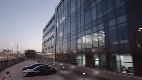 Drone Flying Upward Past Business Center Dusk