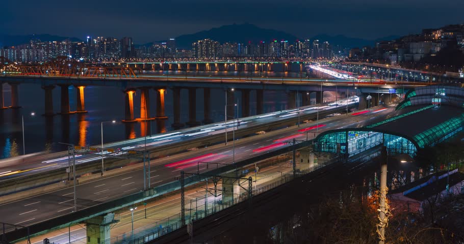 Elevated Night Time Lapse of Traffic Light Trails at Oksu Station Intersection, Gangbyeonbuk-ro Expressway and Donho Bridge, Seoul, South Korea