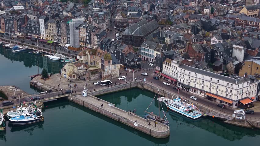 La Lieutenance building and tour boats at the entrance of the Vieux Bassin in Honfleur, France. Aerial drone view