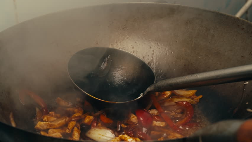 Asian Wok noodles cooking, Chef cooking handmade pasta wok frying pan close-up. Chinese traditional beef and chicken vegetables on fire pan, japanese korean pasta. Restaurant Food concept. Sea food.