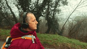 Reflective walk of a 50 year old man in the quiet, foggy and rainy forest for stress management and emotional balance. - Powered by Shutterstock - Get 15% off with code: PIKWIZARD15
