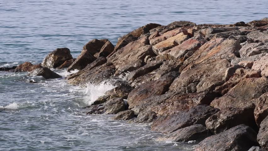waves crashing on rocks blue ocean