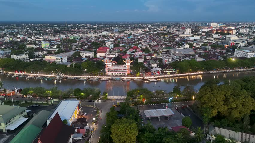 a view from above Banjarmasin city highlighting the 0KM monument at sunset