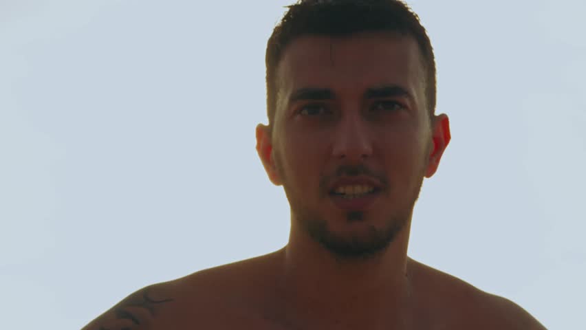 Low angle view of a handsome tattooed man