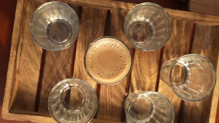Indian chai served in glass cups, brewed in a metal kettle with aromatic masalas.