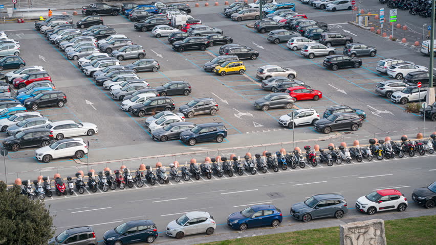 Busy parking lot and scooters in Piazza della Vittoria, Genova, timelapse