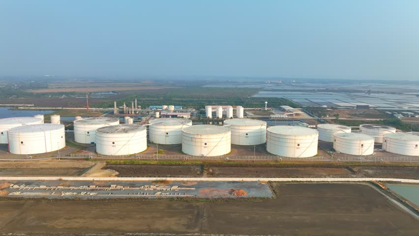 Drone perspective of crude oil storage tanks in an energy facility, highlighting logistics coordination, infrastructure reliability, fuel management, and operational control.
