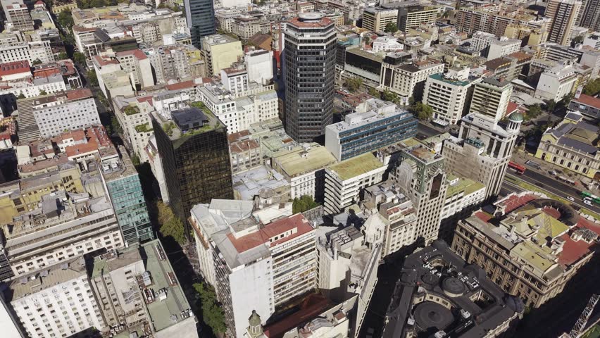 Aerial drone view of downtown Santiago showcasing dense architecture and metropolitan movement for editorial and commercial visuals. Chile, 4K