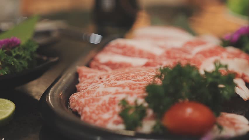 Galbi sizzling Korean BBQ experience showing dynamic cooking action with smoke and grill marks for authentic restaurant scene.