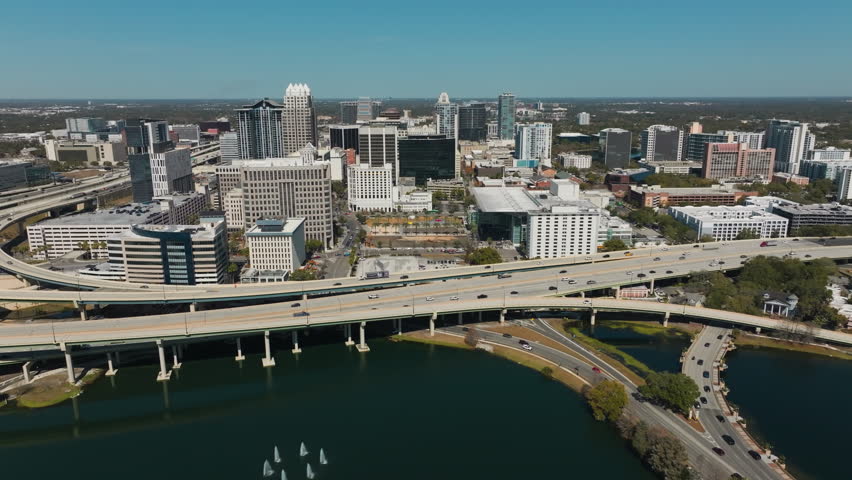 A panoramic aerial view highlights the scale, growth and metropolitan rhythm of downtown Orlando’s urban landscape.
