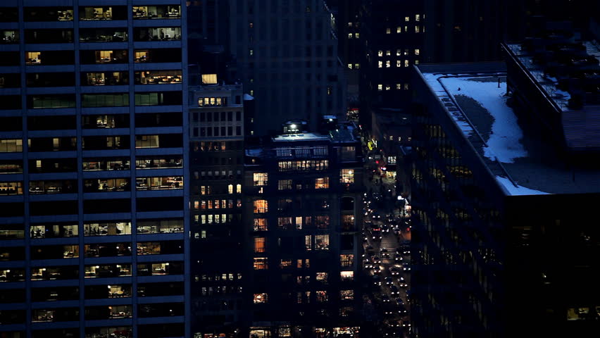 Cars moving slowly surrounded by enlighted skyscrapers, Manhattan, New York City
