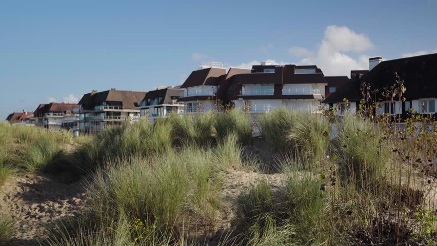 Beach front houses behind dune with grass in Knokke Belgium