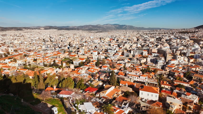 Wide cityscape view of the urban sprawl with Mount Lycabettus in the distance, Athens, Greece
