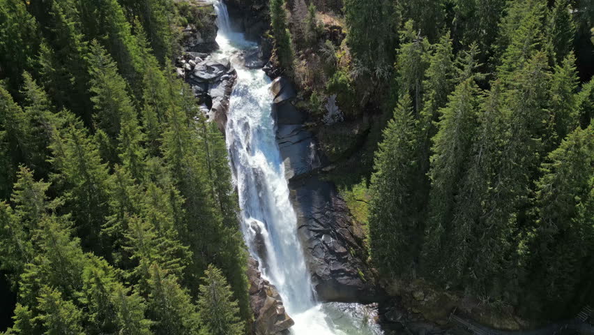Aerial tilt view of Krimml Waterfalls in forest mountain. High Tauern National Park, Austrian Alps, Austria, 4k