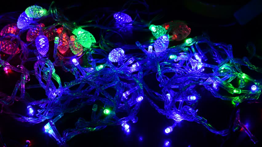 Led Christmas lights in shape of fir cone and the usual on wooden table