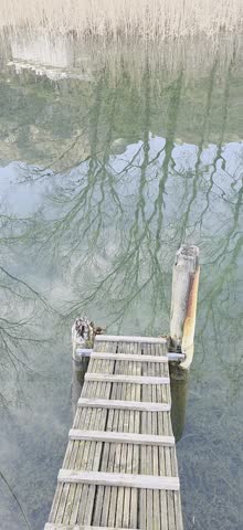Lake wood pier, water reflections, trees, water waves, winter landscape
