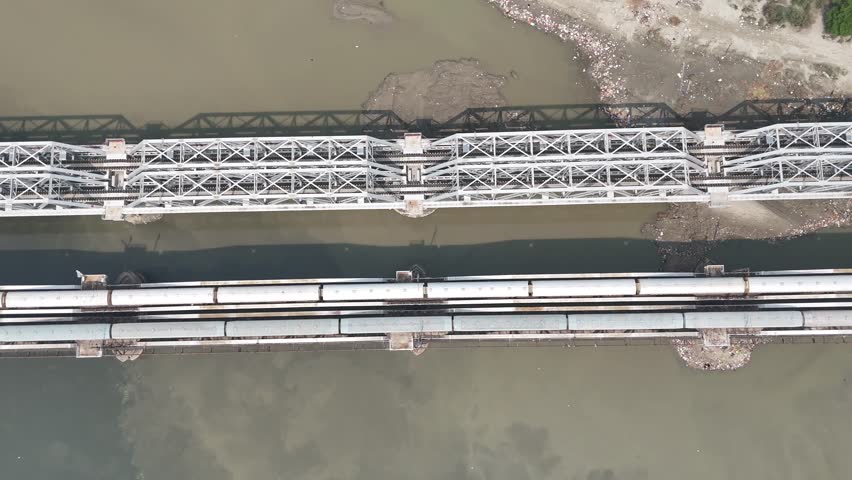 Aerial view of old iron bridge, Loha pul at Yamuna River in Delhi, Train is going on the bridge
