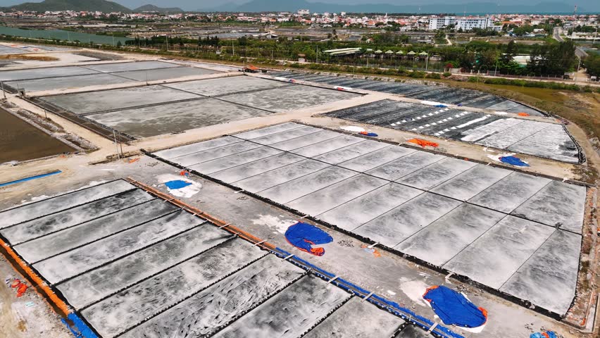 Aerial view of nha trang salt fields in vietnam showing traditional salt farming and production from seawater evaporation.