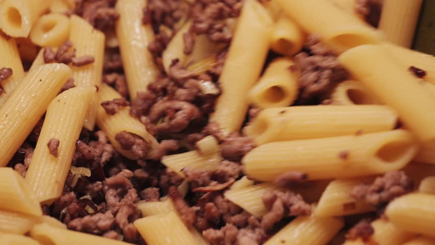 Cooking Bolognese Pasta in a Pan. Penne Pasta with Ground Beef.