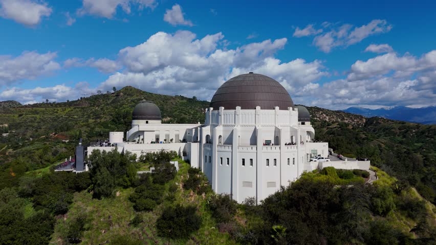 Griffith Observatory aerial drone orbit over hilltop landmark in Los Angeles California, February 20, 2026