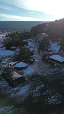 Bird’s-eye view of Batak Reservoir featuring a tranquil island in the center, with the surrounding hills reflected in the water. The natural harmony of lake, island, and mountains creates a breathtaking panorama.