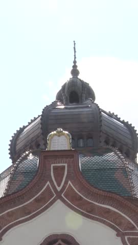 Vertical editorial view of the historic Novi Sad Synagogue exterior.