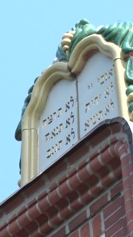 Vertical editorial shot of the architectural details of the Novi Sad Synagogue facade.