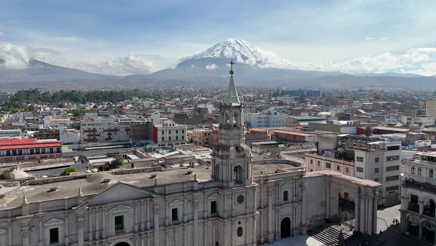 Arequipa Cathedral tower and the snow-capped Misti volcano during the rainy season in Arequipa, Peru