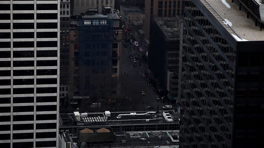 Small cars flowing with traffic under big skyscrapers / HD1080 / 29.97fps