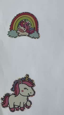 Cute cartoon unicorn and rainbow stickers on white background – seamless loop decorative video
