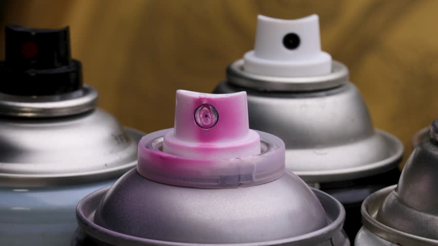 Various Spray Paint Can Nozzles and Colours Close Up Left to Right