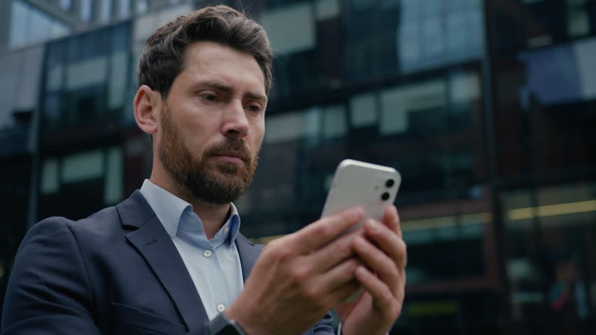 Upset sad man Caucasian businessman using mobile phone in city fail lose message guy male entrepreneur business client outside smartphone worried frustrated online gambling app problem stress outdoors