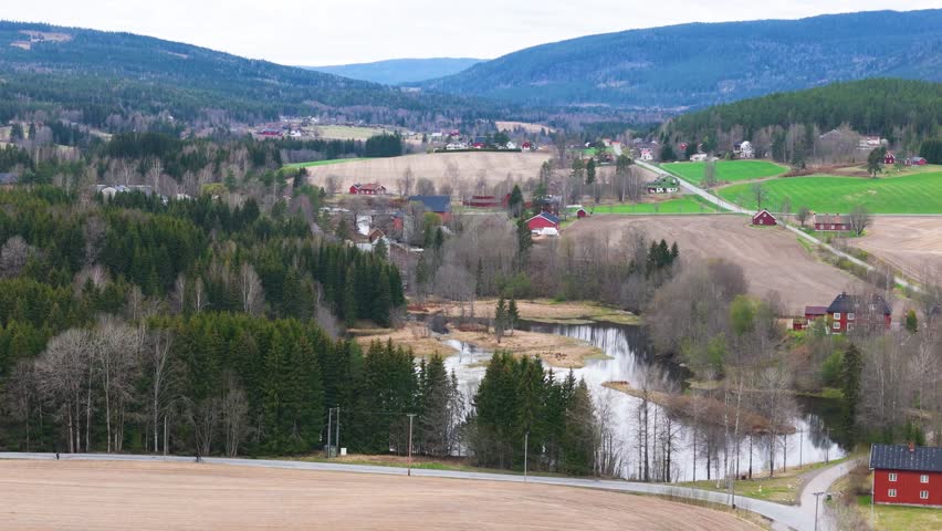 reflective ponds sit among dense evergreen forest layered mountain ridges form calm backdrop norway aerials drone view mountains nordic landscape