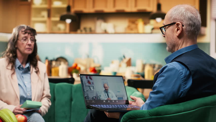 Retired man and woman, telehealth services, medicine box, pills dosage, pensioner connecting with doctor on video consultation and discussing medication administration. Telemedicine.