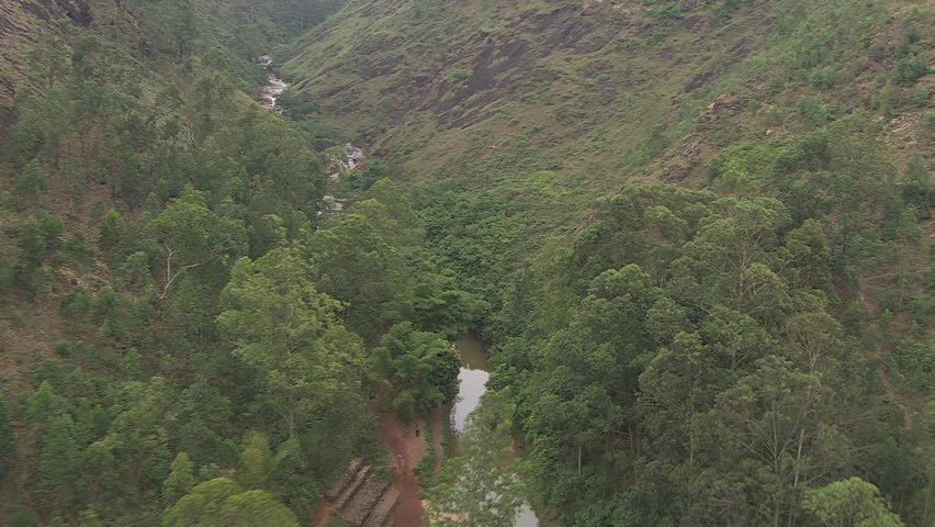 untouched land with tall trees and multiple waterfalls in Africa