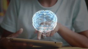 Boy tapping and swiping tablet while activating rotating blue 3D brain model for medical education. Interactive, technology, innovation, education, visualization, pediatric, futurism - Powered by Shutterstock - Get 15% off with code: PIKWIZARD15