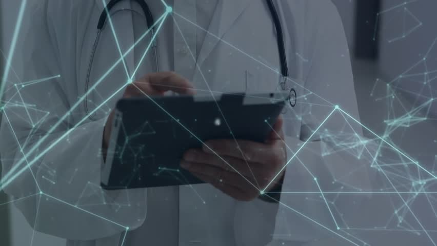 Animation of icons connected with lines over caucasian doctor using digital tablet in corridor. Digital composite, multiple exposure, profession, hospital, medical, healthcare, technology concept.