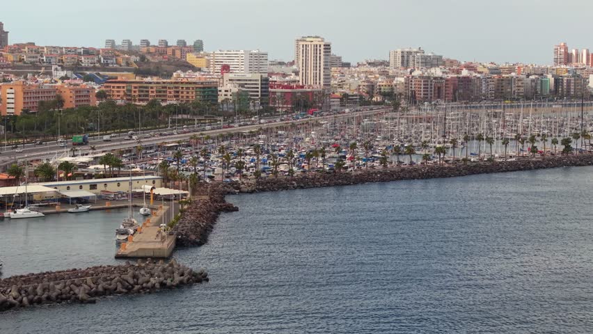 Breathtaking panorama of the marina port in Las Palmas, Gran Canaria, with the city and coastal highway in the background