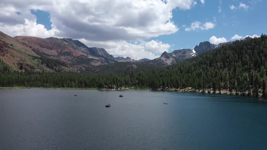 Panoramic aerial forward panning drone shot of Lake Mary in Mammoth Lakes and its surroundings in the Sierra Nevada Mountains