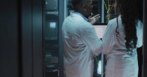 Scientists discussing data analysis over graph animation in server room. Technology, innovation, research, teamwork, collaboration, analytics - Powered by Shutterstock - Get 15% off with code: PIKWIZARD15