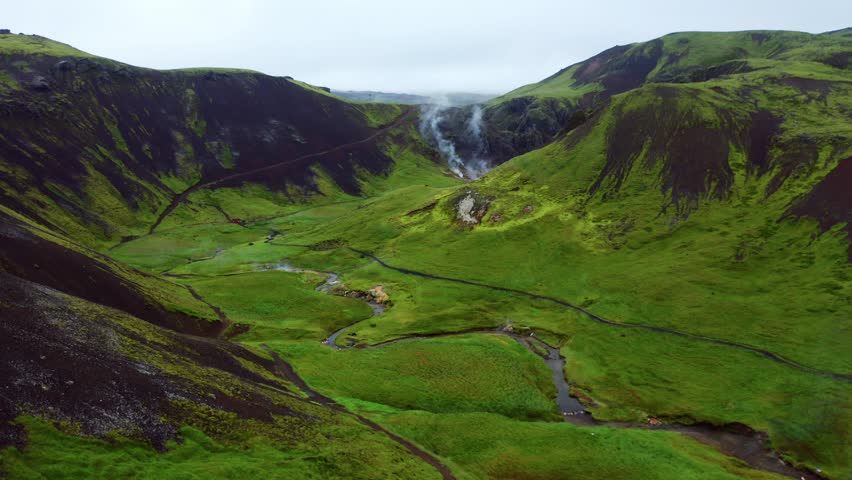 Steam From The Narrow River At The Green Valley Of Reykjadalur Near Hverageroi In South Iceland. aerial