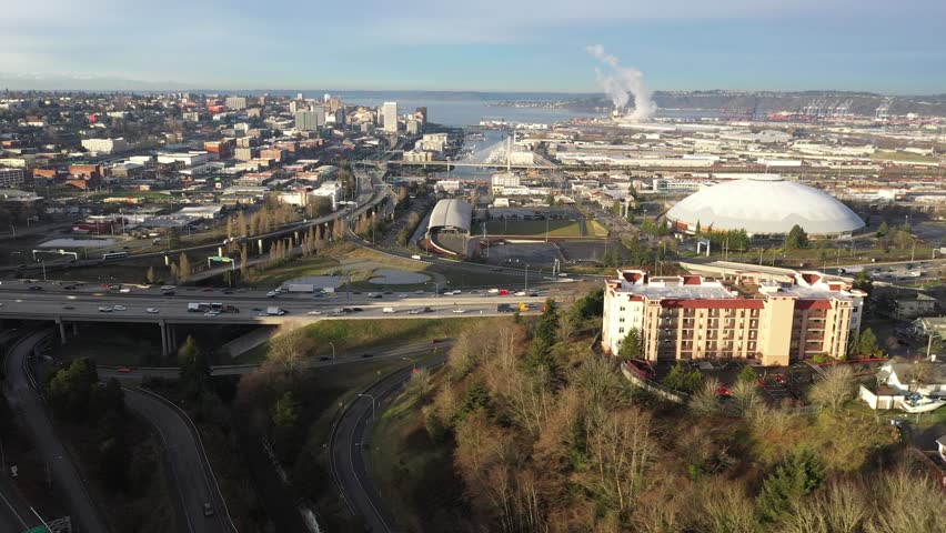 Cinematic drone tracking shot of downtown Tacoma, harbor, dome, Commencement Bay, cargo terminals, I-5 interstate, Puget Sound, port of Tacoma, near Seattle, Washington, Pierce County