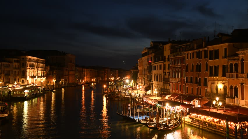 Venice, Italy night time lapse of busy canals at famous tourist destination