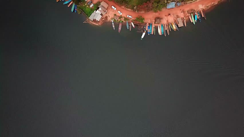 Top View Of Wooden Fishing Boats Docked On The Shore Of Lake Bunyonyi, Uganda. Aerial Shot
