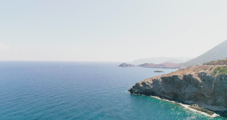 A shot from a drone of a road on the coast of the Greek island of Crete
