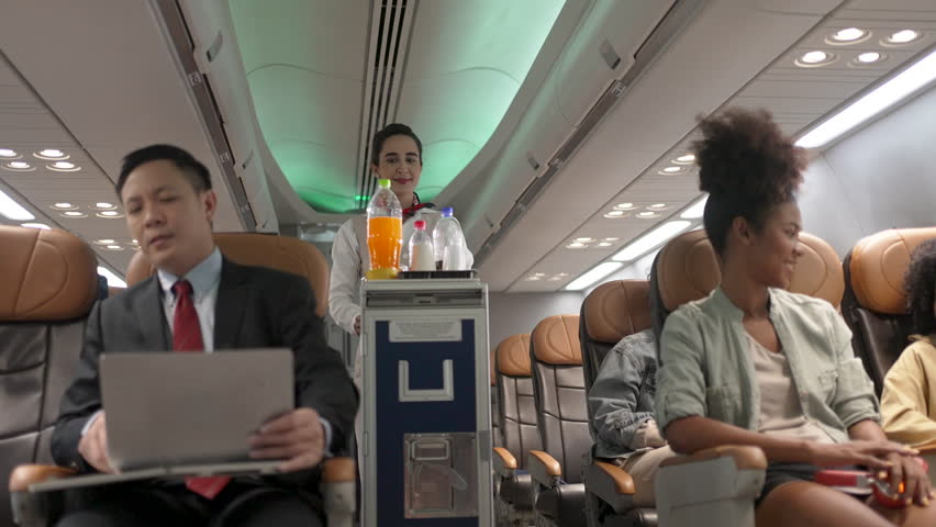 Passengers are sitting in the passenger cabin while travel by commercial air plane. Transportation, Travel, air plane.